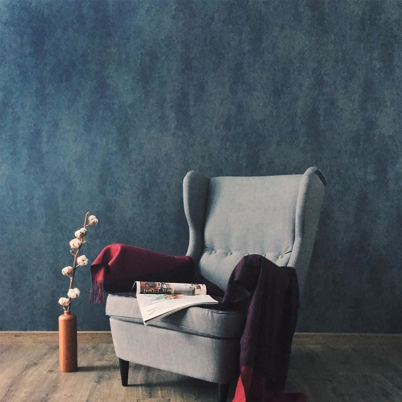 Blue vinyl wallcovering with upholstered chair